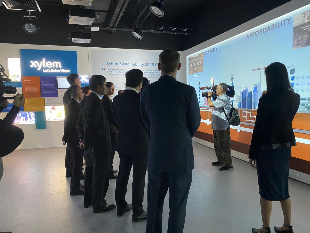 Guests touring a newly opened gallery with a projected wall along its length
