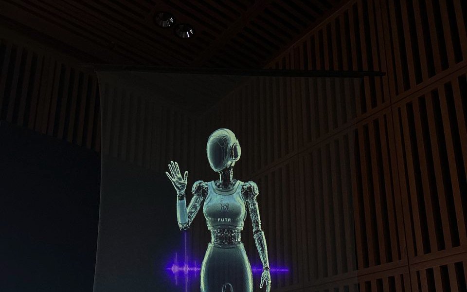 An animated 3D character appearing as a life-size hologram on stage