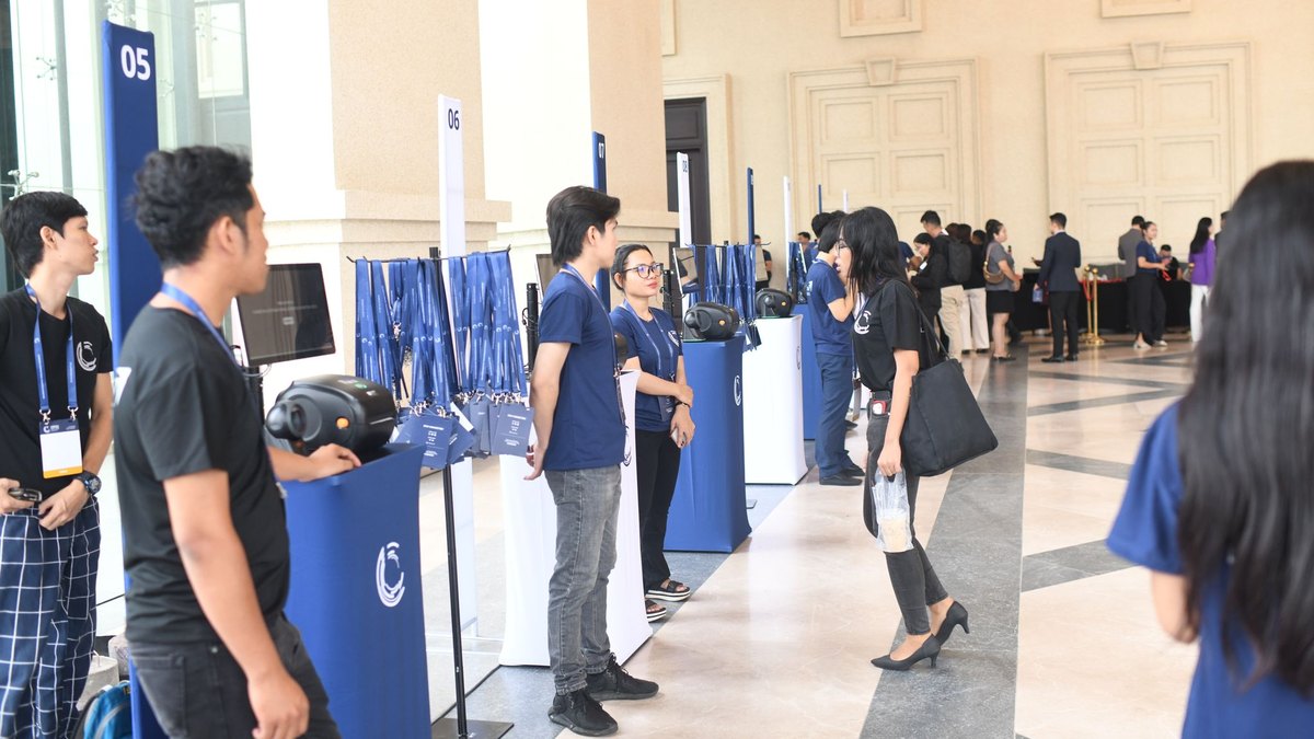 A row of numbered check-in stations with staff ready for arrivals