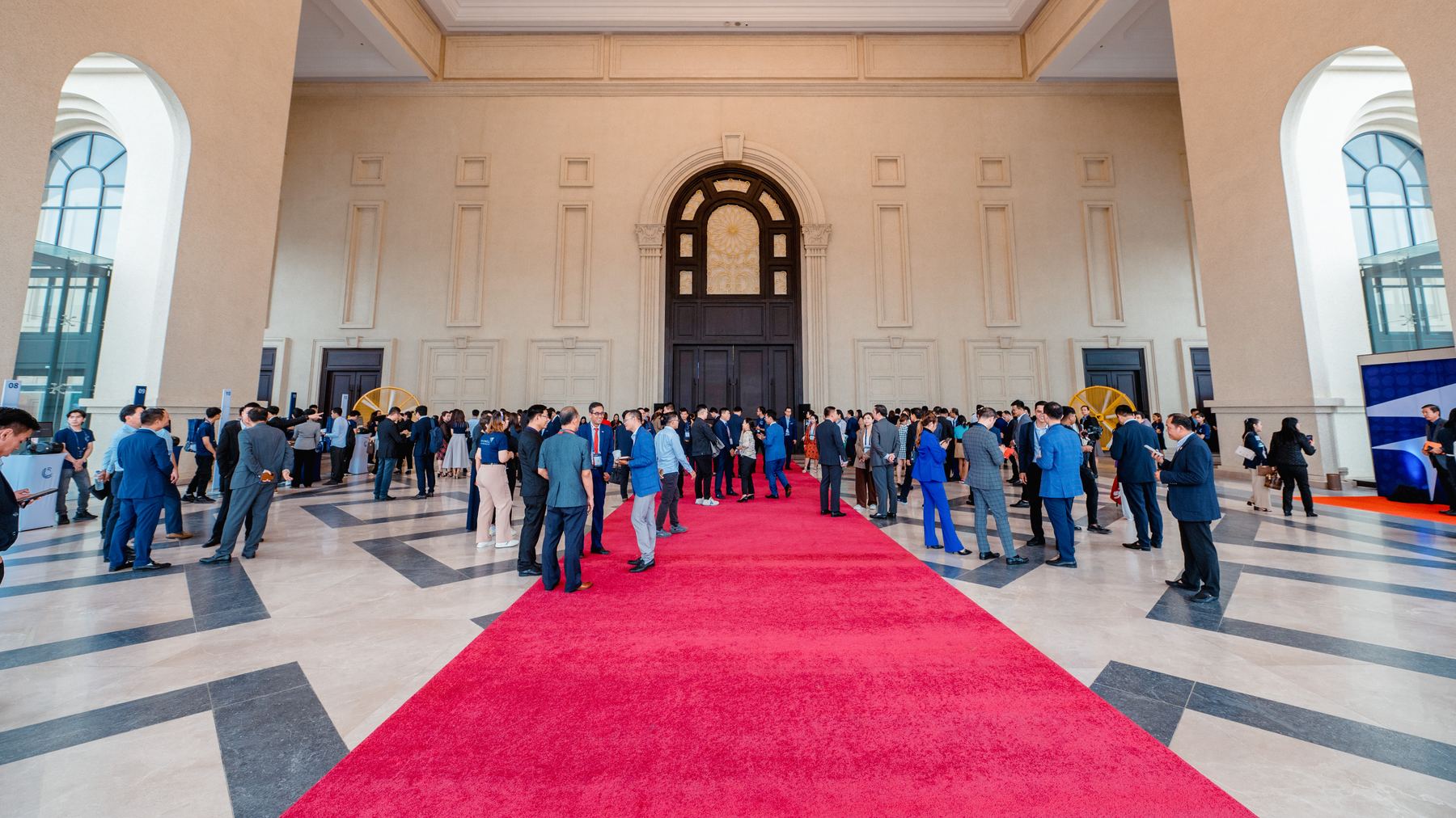 Guests gathering in a grand hall at a leadership conference we produced